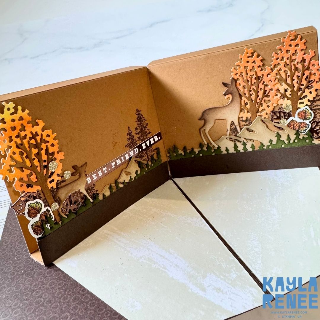 Detailed view of the right side of the pop-up scene showing a standing deer among autumn trees and forest textures. Sentiment strip reads ‘Best. Friend. Ever.’ in white.