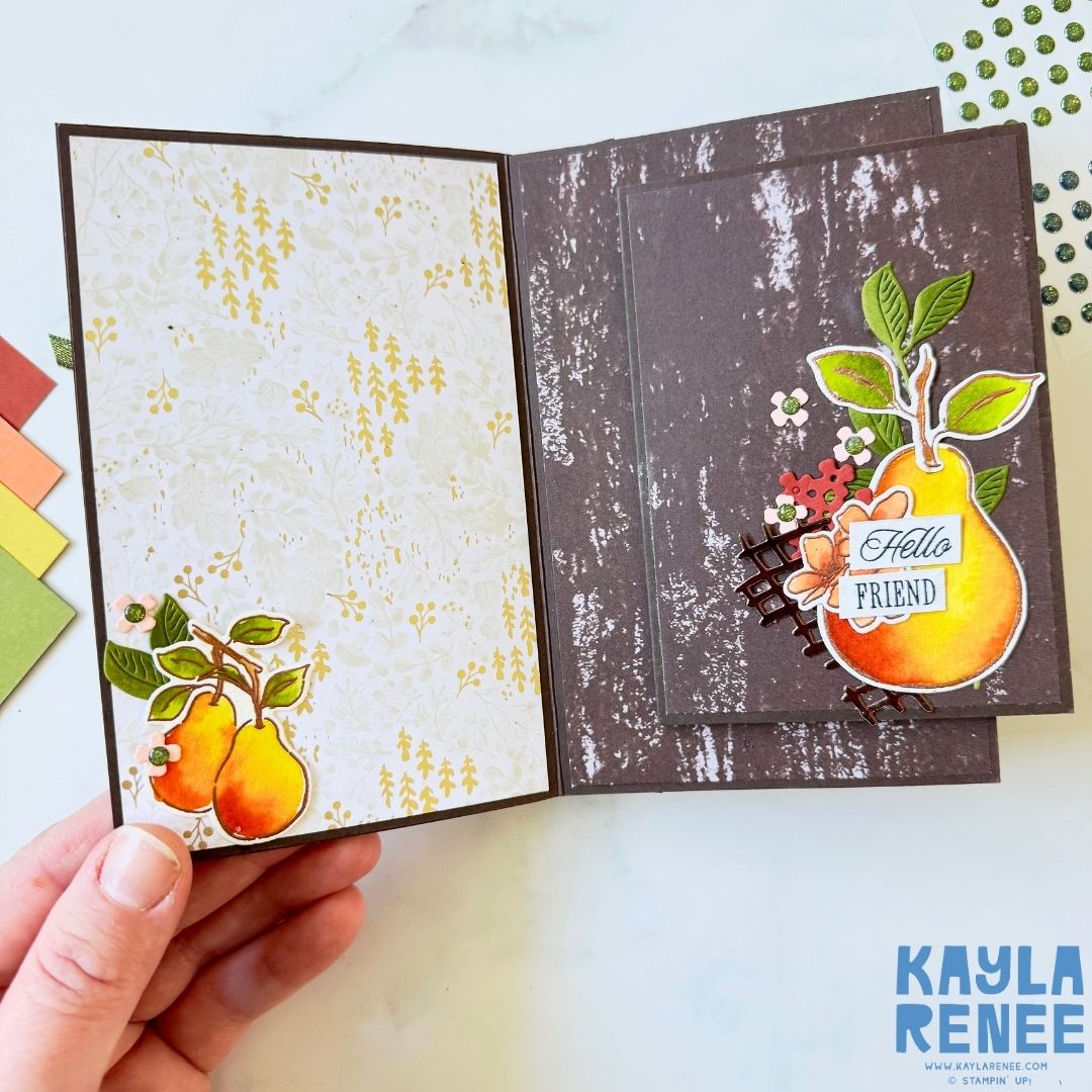 Open view of the fun fold card showing two inside panels: one with a light cream patterned background and pears in the corner, and the other with a dark textured panel featuring a pear and the sentiment ‘Hello Friend.