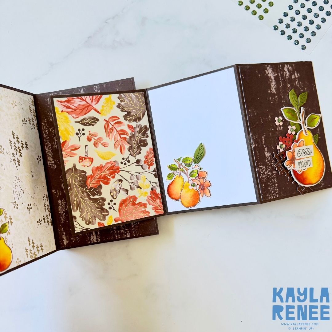 Fully opened view of the interactive card layout displaying autumn-themed patterned paper with leaves, a white writing panel, and watercolour pears in coordinating colours. The right panel features the sentiment ‘Hello Friend.