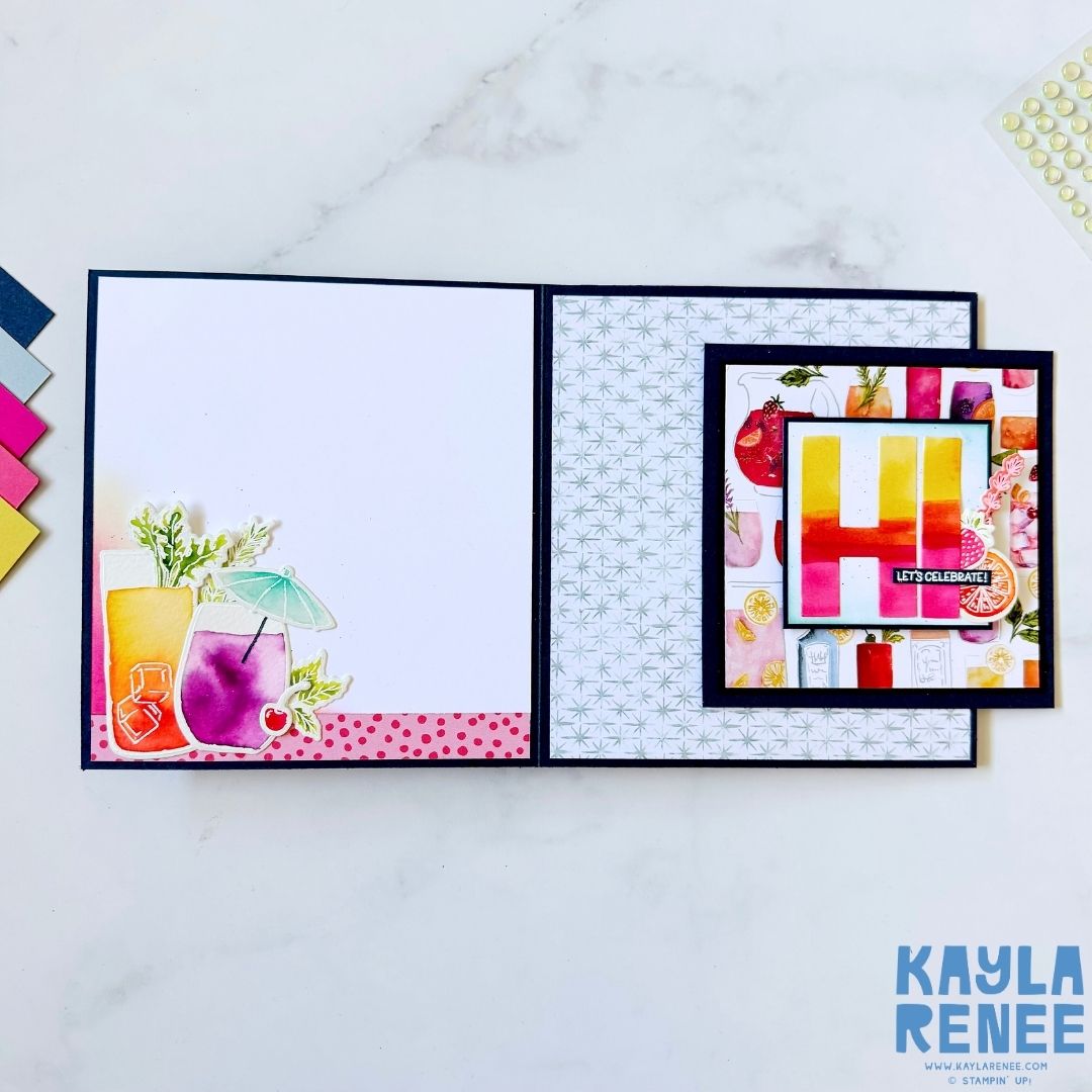 Card opened to reveal the interactive side slide-out design with colorful patterned papers and a section that reads ‘HI Let’s Celebrate!’ in bold gradient letters. The left panel has watercolor cocktail images with a pink polka-dot border.