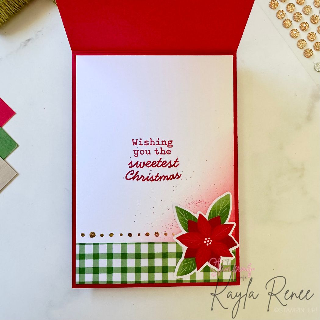 Inside of the Christmas card featuring a clean white panel with a green gingham strip and gold dot border at the bottom. A red poinsettia embellishment decorates the lower right corner, and a red sentiment in the center reads “Wishing you the sweetest Christmas.” Light pink ink blending decorates the bottom right area.