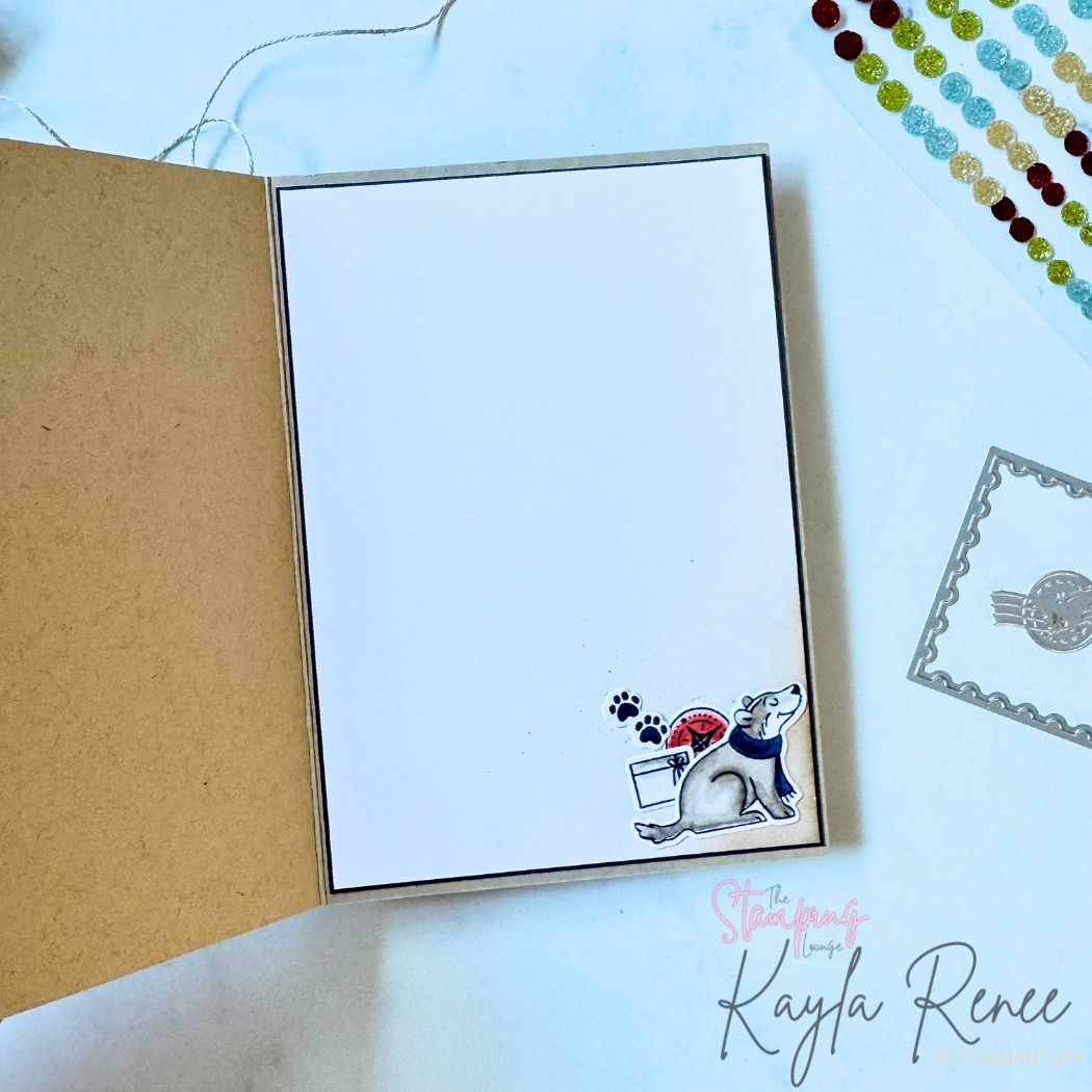 Inside of handmade Christmas card featuring simple clean design with small stamped and coloured pup holding a letter, paw prints, and festive envelope cluster in bottom corner. Blank space for personal greeting. Coordinates with matching card front made using Stampin’ Up! products.