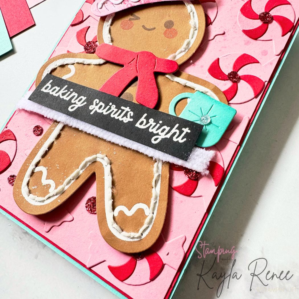 Close-up of the gingerbread card showing layered die-cut details, stitched icing accents, peppermint elements, and heat-embossed sentiment strip. Mixed textures and glitter embellishments highlight Stampin’ Up! Christmas card making techniques.