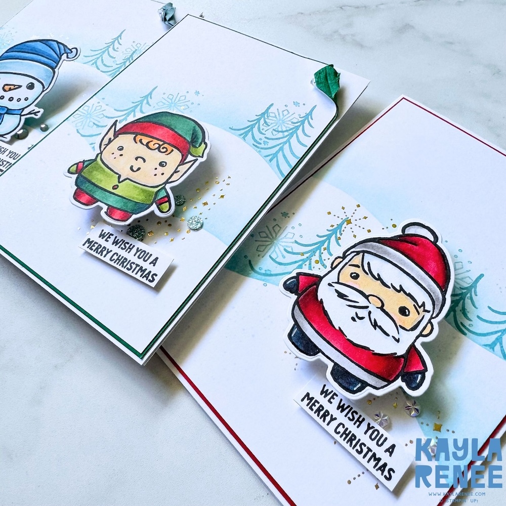 Close-up of handmade Christmas cards using the Stampin’ Up! Festive Friends bundle, showcasing cute elf and Santa images with blended ink backgrounds, festive sparkle accents, and layered sentiments.