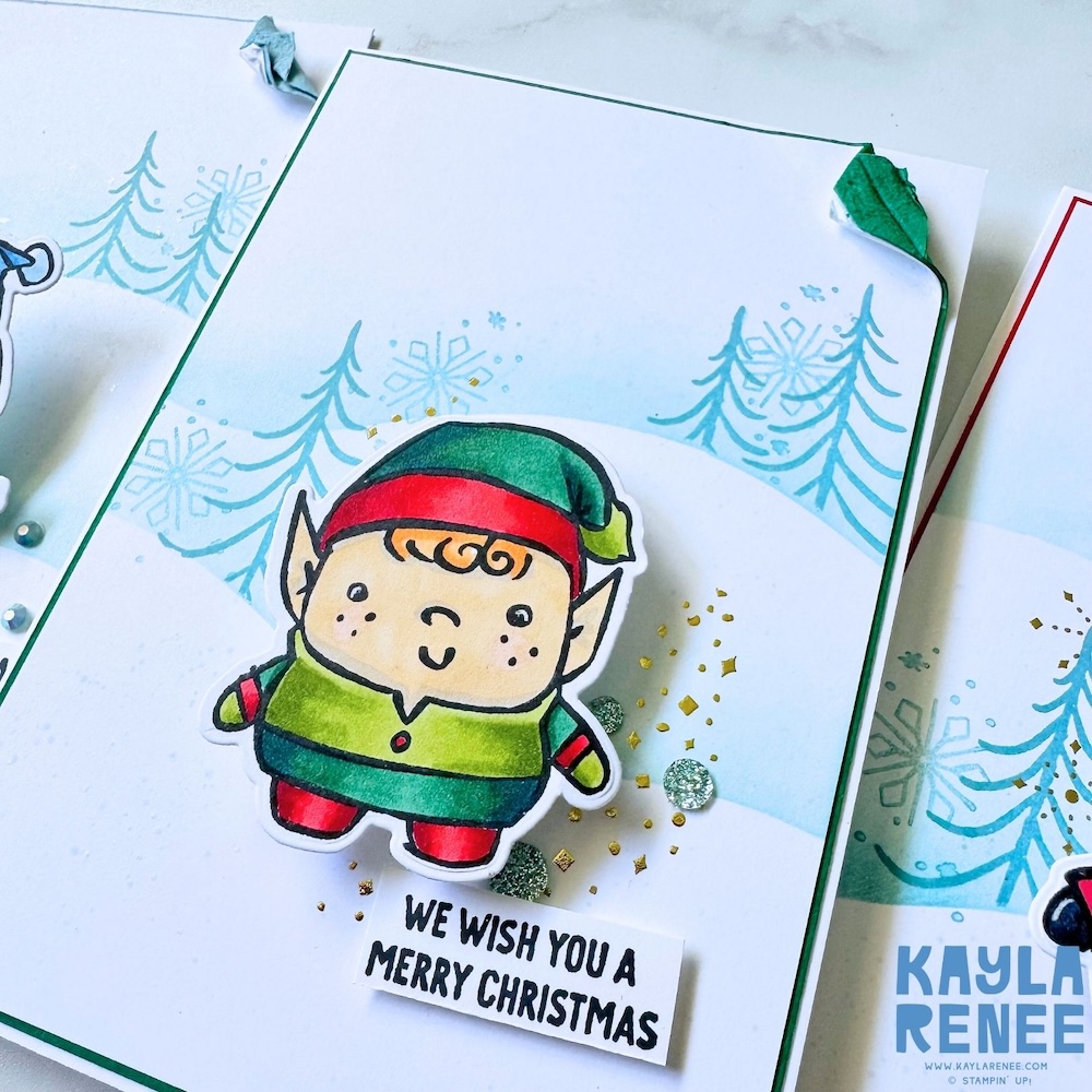 Handmade elf Christmas card created with the Stampin’ Up! Festive Friends bundle, featuring a coloured elf image, snowy landscape background, stamped pine trees, and “We wish you a Merry Christmas” sentiment.