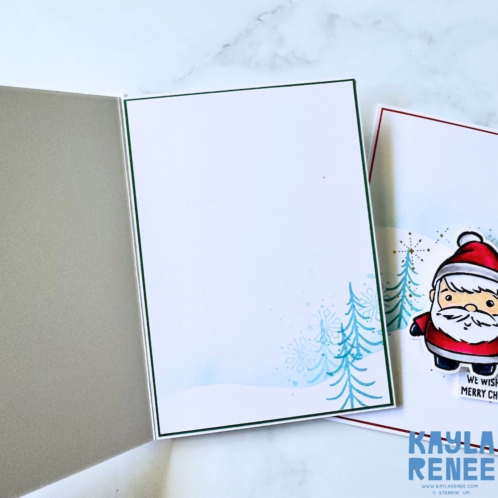 Inside view of a handmade Christmas card using the Stampin’ Up! Festive Friends bundle, with a clean white writing panel and subtle stamped winter trees for a simple festive finish.