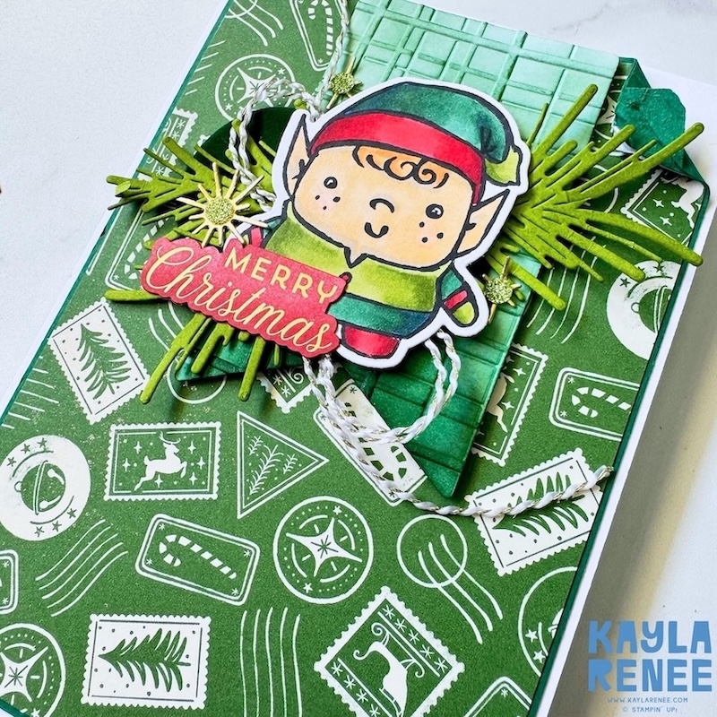 Close-up of an elf image from the Stampin’ Up! Festive Friends bundle on a green Christmas card, with layered foliage, twine and festive embellishments.