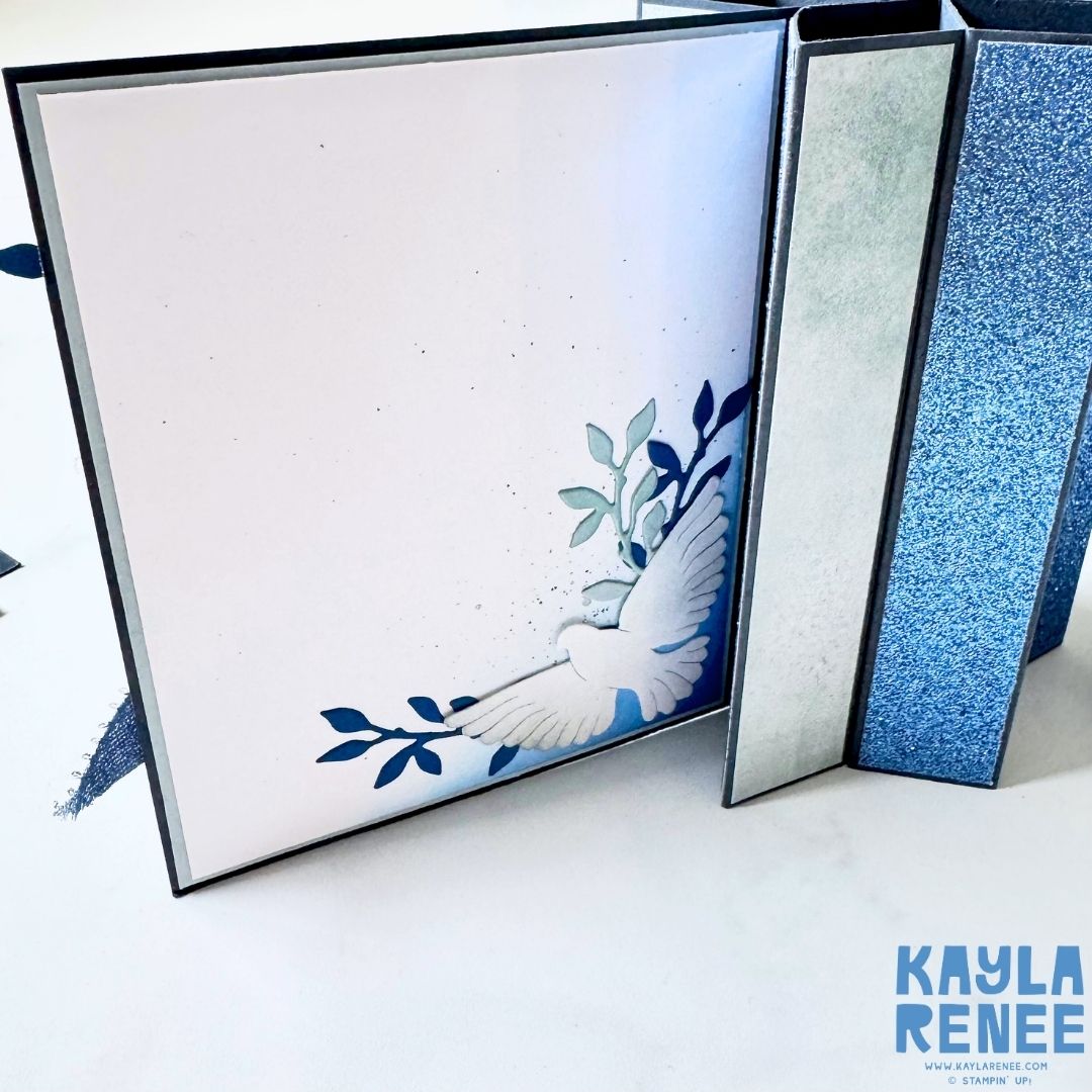 Inside panel of handmade star fun fold Christmas card by Kayla Renee, featuring soft ink blending, a white dove die-cut, and leafy blue branches. Clean minimal design for handwritten message space.