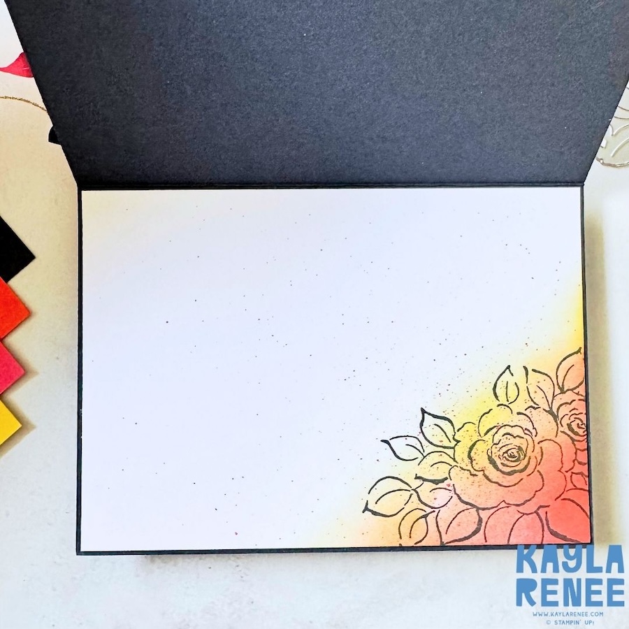 Inside view of the handmade card featuring a clean white writing panel with a subtle stamped floral image in the bottom corner, softly blended in yellow and coral tones to coordinate with the Party Alphabet letter design on the front.