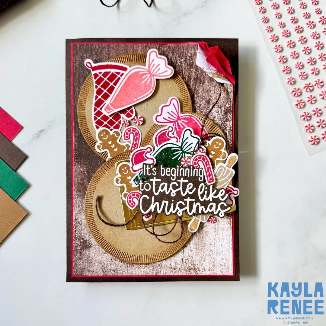Handmade Christmas card created by Kayla Renee using the Stampin’ Up! Homemade Treats bundle. Features candy canes, gingerbread men, and peppermint sweets with the sentiment “It’s beginning to taste like Christmas” layered on stitched circles over rustic woodgrain paper.