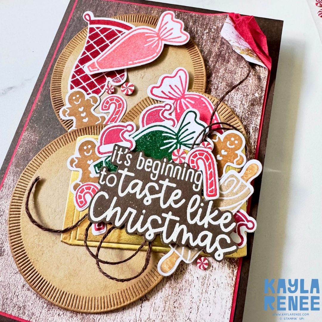 Close-up of a festive handmade Christmas card by Kayla Renee featuring the Stampin’ Up! Homemade Treats bundle. Highlights include die-cut candies, gingerbread shapes, and red and green sweets surrounding the heat-embossed sentiment “It’s beginning to taste like Christmas.”
