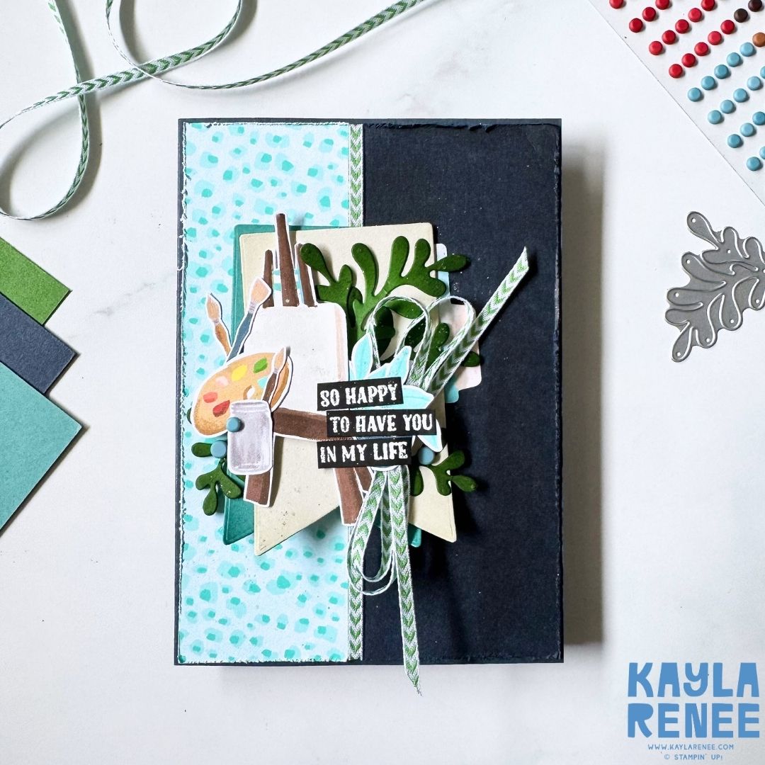 Handmade greeting card created with the Stampin’ Up! Hobby Haven Suite, featuring layered craft-themed die cuts, foliage, twine, and a sentiment reading ‘So happy to have you in my life’ on a modern split-panel background.