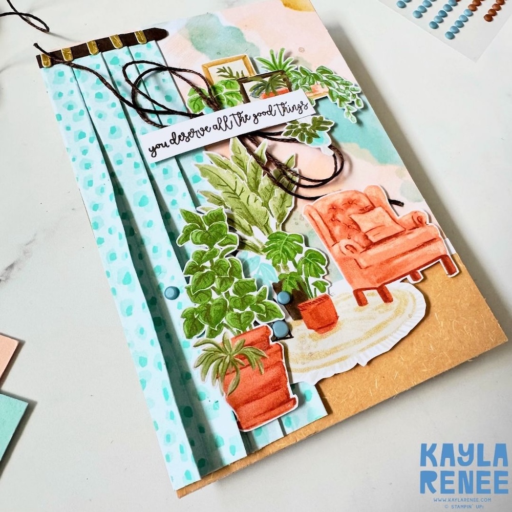 A close up look at a handmade card showing an angled view of the card embellishments including the indoor plant designs and couch featuring the Stampin’ Up! Hobby Haven Suite