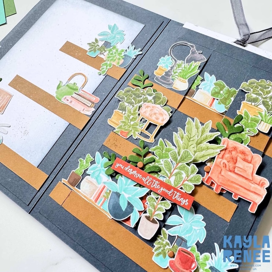 Close-up detail of layered die-cut plants, sentiment strip, and enamel dot embellishments on the interactive slider card.