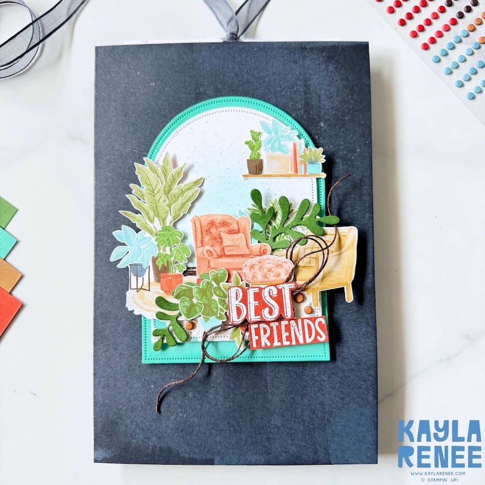 Handmade multi-panel slider card with a dark charcoal base, arched window frame, layered houseplant illustrations, a cozy armchair, and a red “Best Friends” sentiment tied with twine.