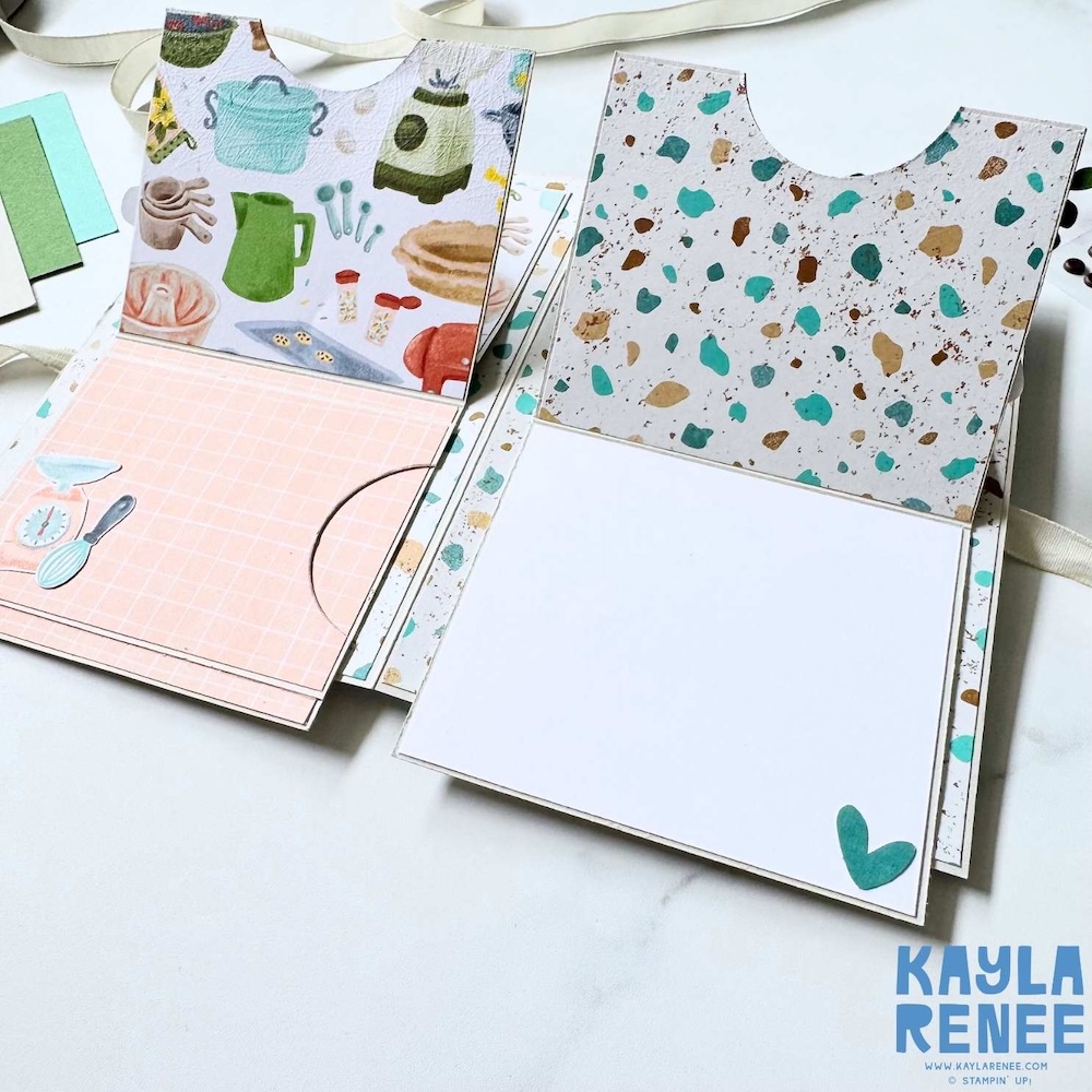 Fully opened handmade interactive card showing two pull-down panels with kitchen illustrations, leafy accents, and sentiments reading “you deserve all the good things” and “so happy to have you in my life.”