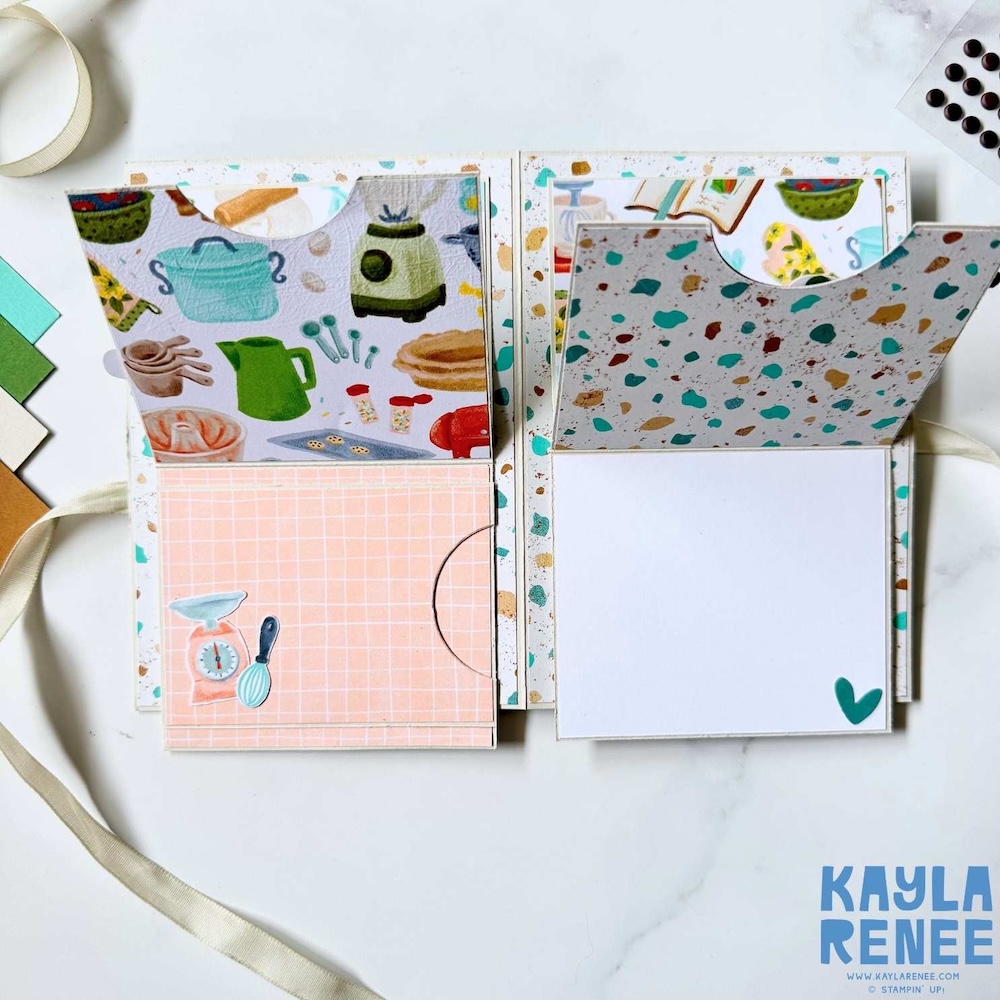 Interior of pull-down pop-up card displaying layered patterned paper, curved pull tabs, and hidden writing space revealed when the panels are lifted.