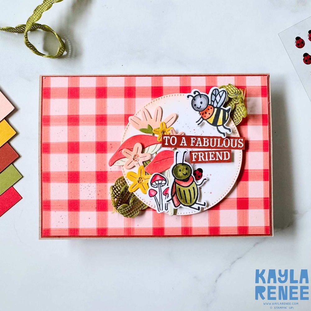 Handmade slimline card with red gingham background featuring stamped bugs, flowers and leaves with a “To a Fabulous Friend” sentiment on a layered circular focal point.