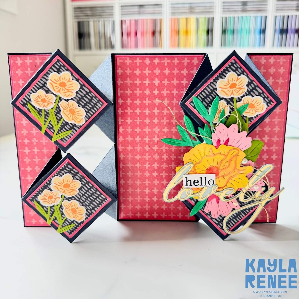 Fully opened floating diamond pop-up card with pink patterned panels, black diamond folds, small stamped flower panels, and a dimensional floral “hello lovely” embellishment.