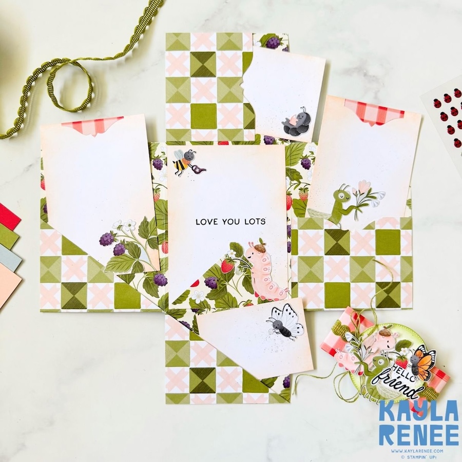 Top-down view of mini album card showing layered pockets and removable inserts, decorated with Cute as a Bug suite papers and playful insect illustrations.