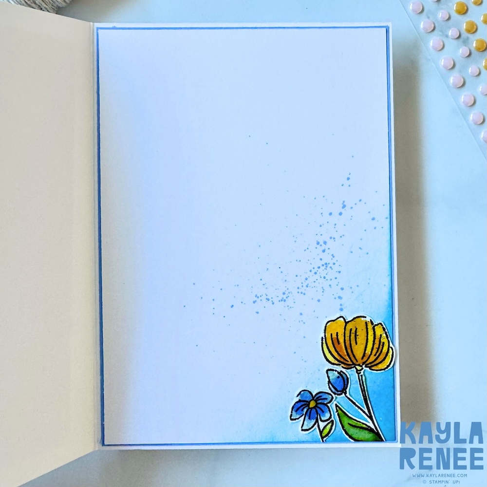 Inside of handmade card with soft blue ink blending, delicate splatter detail, and a single stamped flower in coordinating 2026–2028 In Colours.