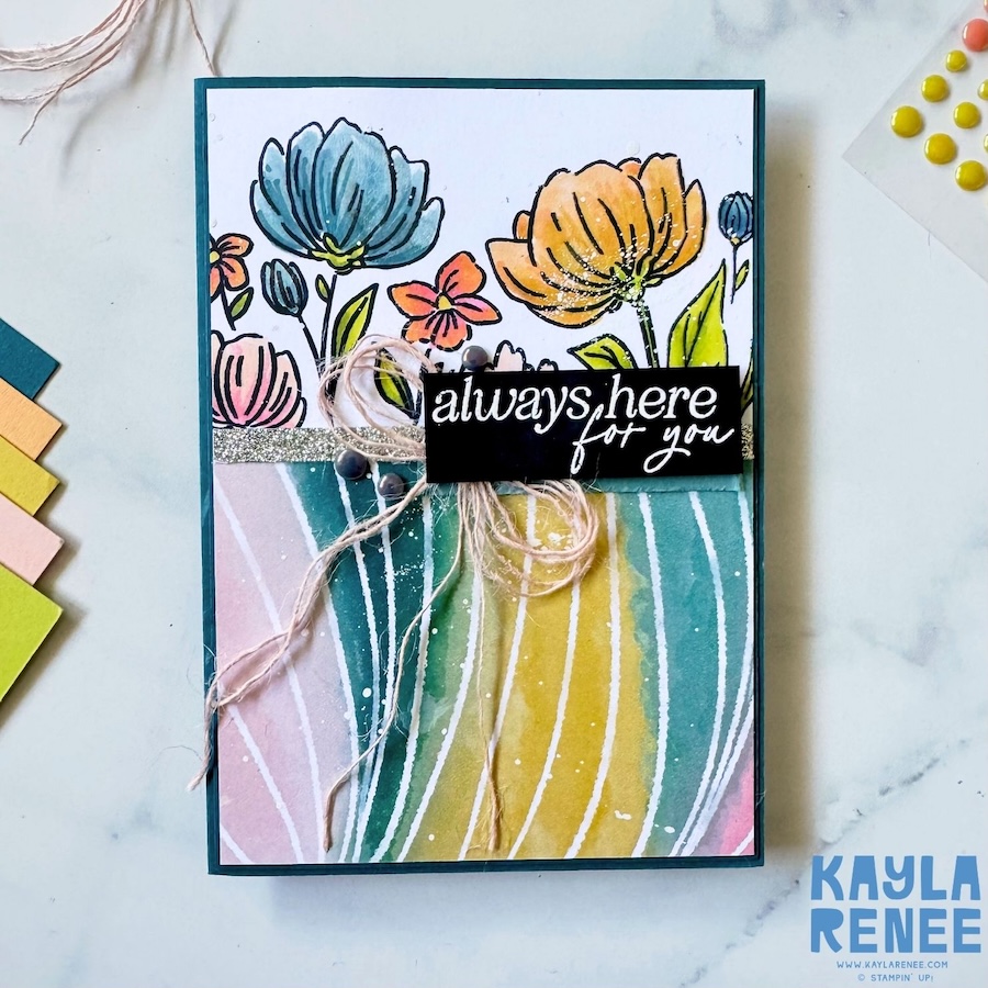 Full front view of a card created using The Stamping Lounge Sketch Box sketch #22, showcasing a floral stamped panel, striped designer paper background, silver glitter strip, and layered embellishments on a deep teal card base.