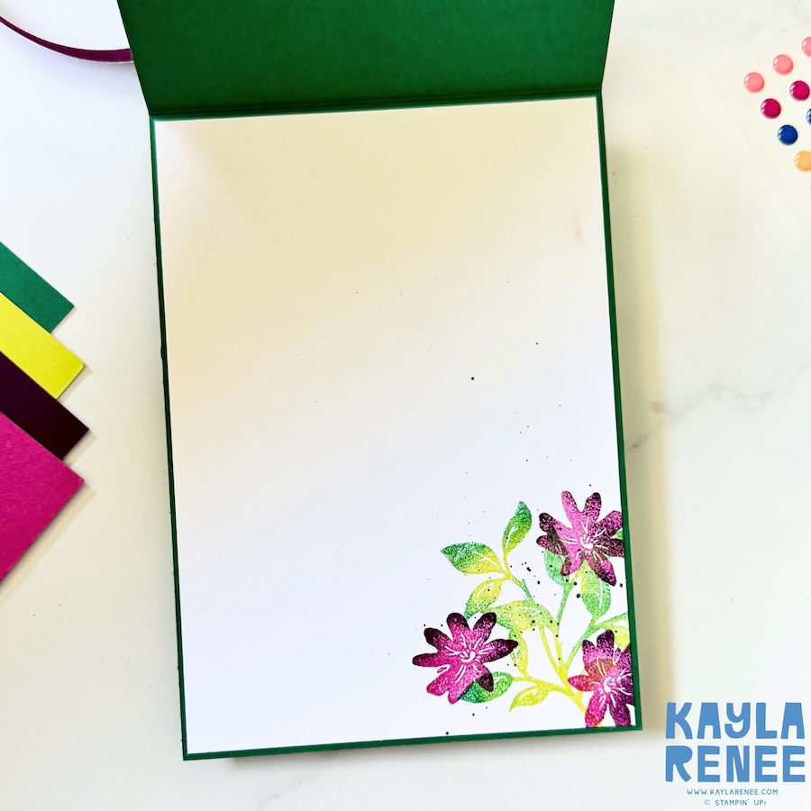 Inside of a Stampin’ Up! Garden Poetry Suite handmade card with a clean white writing panel and stamped floral detail in the bottom corner in coordinating pink and green tones.