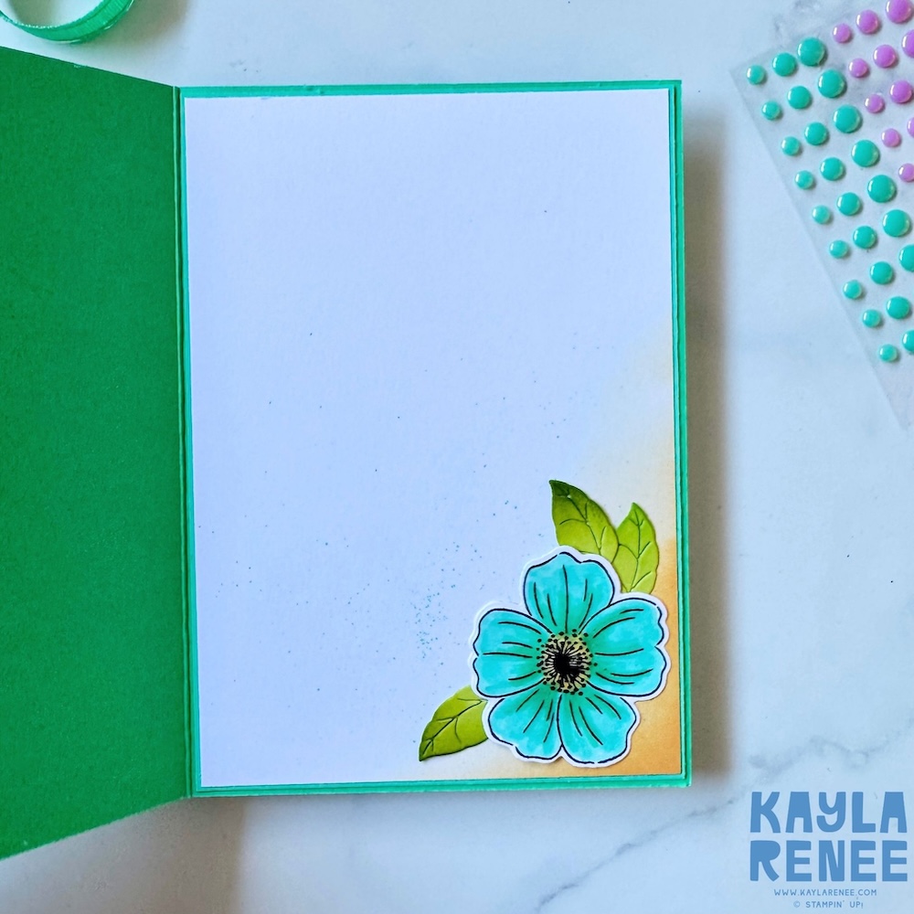 Inside of handmade card featuring clean white writing panel with a single stamped and coloured flower in coordinating 2024–2026 In Colours and soft ink blending in the corner.