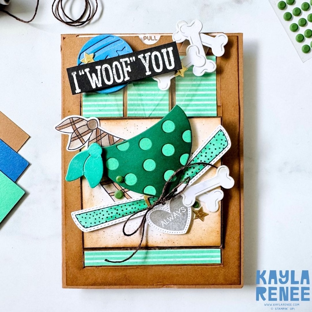 Front view of a handmade Pet Love slider card with layered dog elements, bones, stars, and a bold “I ‘woof’ you” sentiment on a rustic kraft-style background.