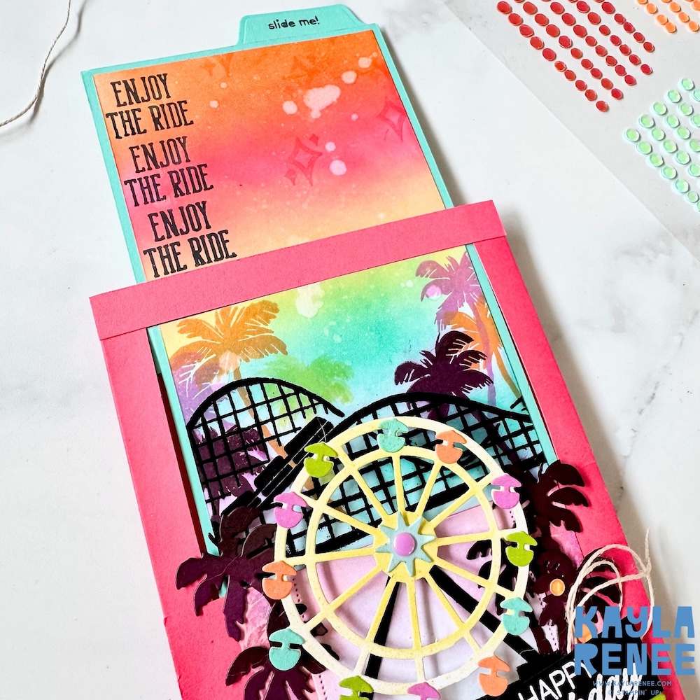 Handmade Stampin’ Up! Beach Boardwalk suite slide and surprise fun fold card featuring a bright pink frame, rainbow ink-blended background, and a pull-up tab revealing a hidden panel stamped with “Enjoy the ride.