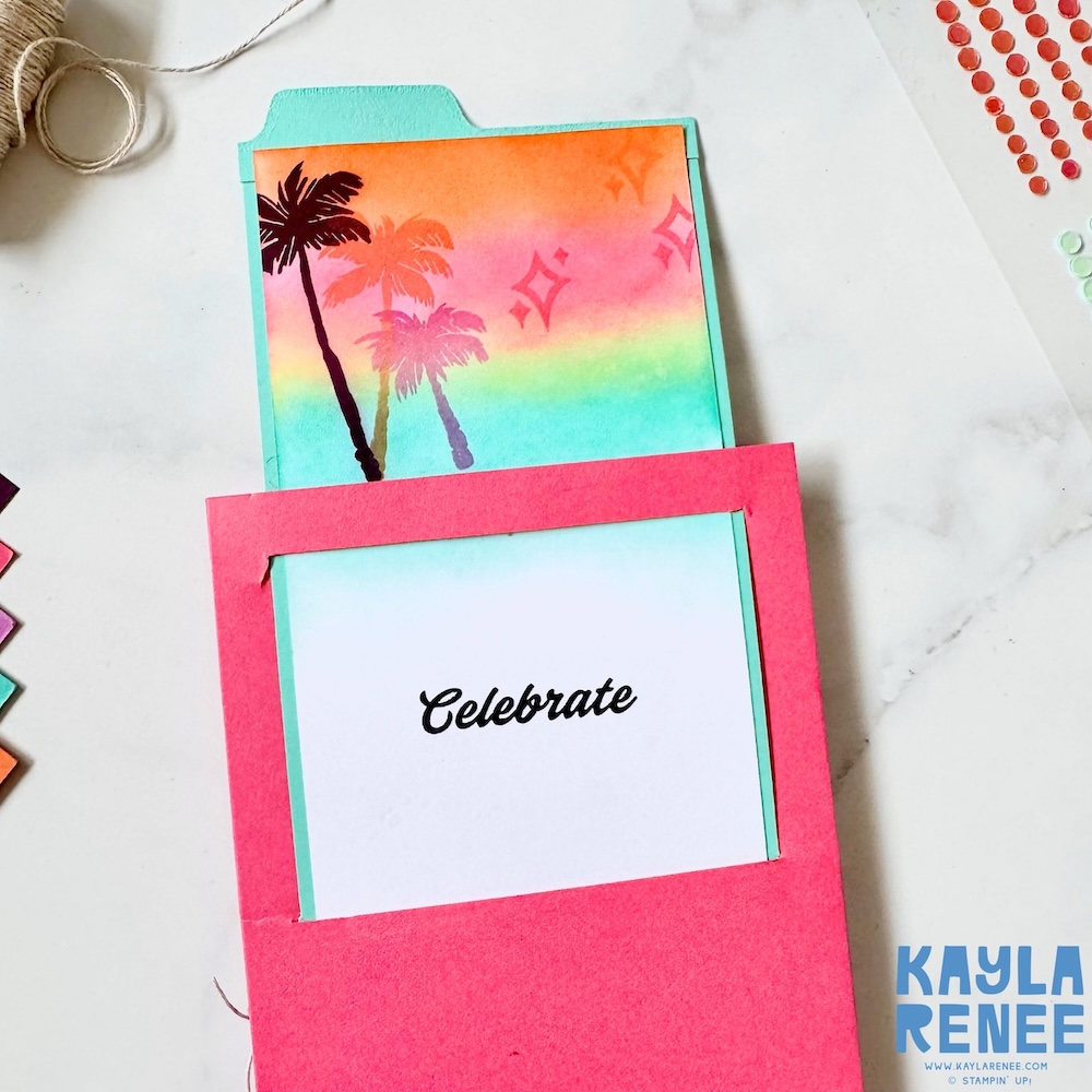 Slide and surprise mechanism of a Stampin’ Up! Beach Boardwalk suite card showing the inner panel with a clean white space and “Celebrate” sentiment revealed through the window opening.