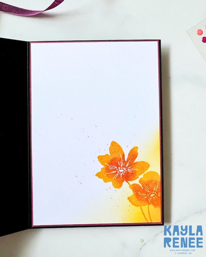 Inside view of a handmade Stampin’ Up! Garden Poetry Suite card featuring a clean white writing panel accented with multi-colour stamped flowers in warm yellow and orange hues. Soft ink blending and subtle splatter details coordinate with the colourful floral design on the card front.