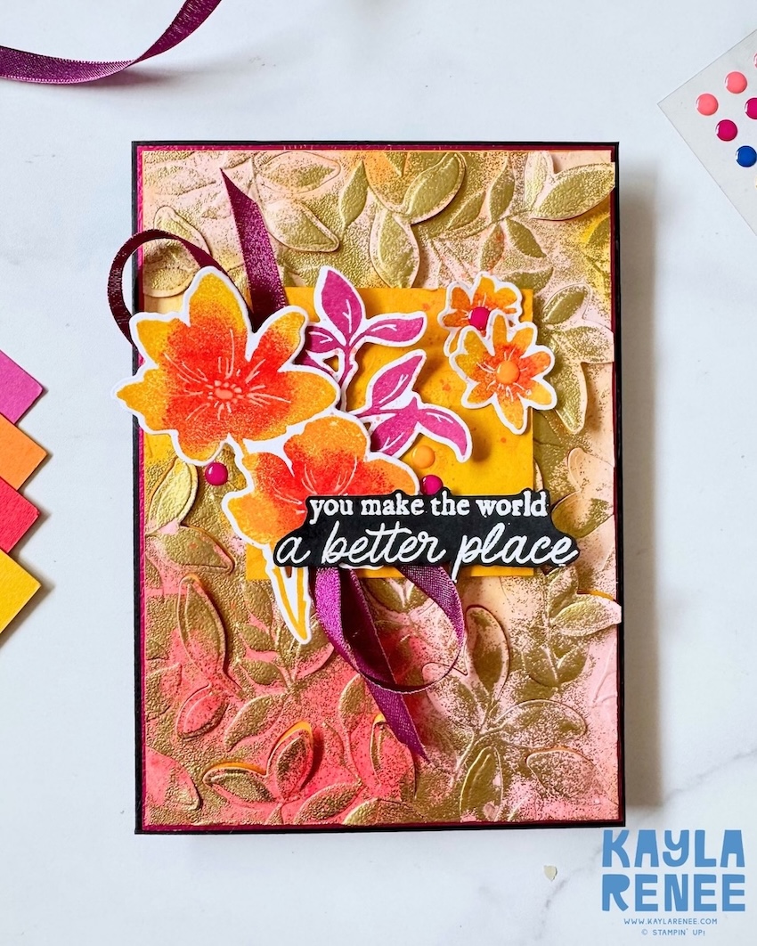 Handmade card created for Global Design Project Challenge #GDP550, inspired by the sketch challenge and featuring products from the Stampin’ Up! Garden Poetry Suite. The card showcases a richly textured background created with a combination of dry embossing and heat embossing, highlighted with blended pink, peach, and golden tones. A layered focal cluster of multi-colour stamped flowers and leaves surrounds the sentiment, “You make the world a better place,” accented with ribbon and coordinating embellishments.