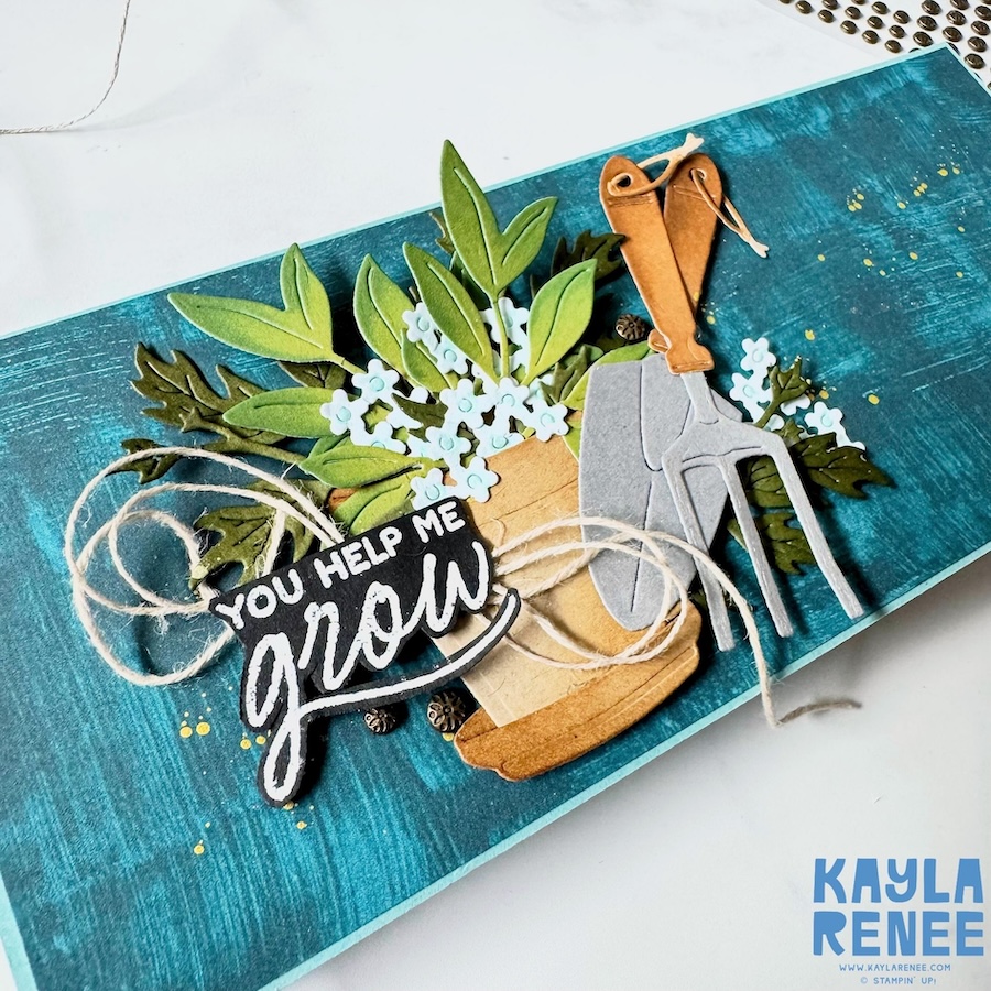 Angled close-up of a Stampin’ Up! gardening themed fun fold card featuring the Nature Walk Designer Series Paper, layered die-cut leaves, tiny flowers, gardening tools, and a bold “You Help Me Grow” sentiment.
