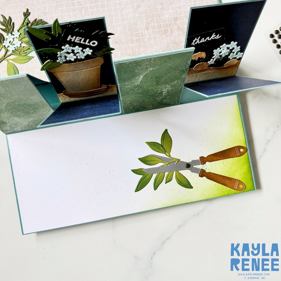 Close-up of the interactive inside panels of a handmade Stampin’ Up! fun fold card featuring layered greenery, potted plants, floral accents, and detailed garden shears from the Help Me Grow Stamp & Die Bundle.