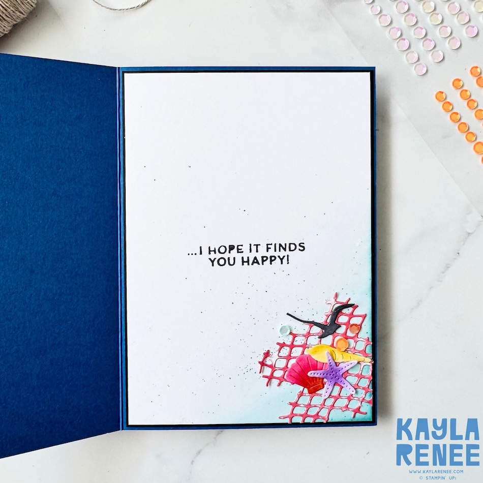 Inside view of a handmade Stampin’ Up! Scenic Coast Suite card featuring a clean white writing panel with a coordinating seaside embellishment cluster, coral netting, seashells, sequins, and the sentiment “…I hope it finds you happy!”