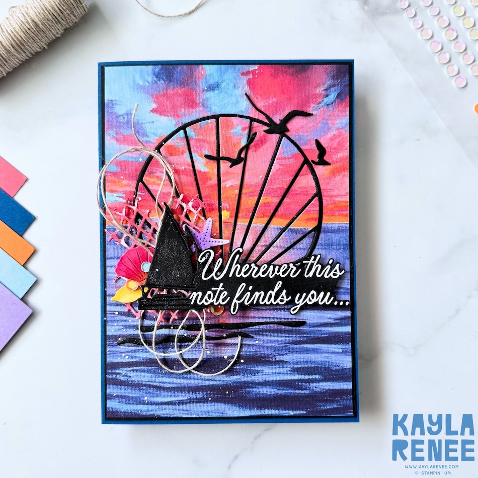 Handmade nautical card created with the Stampin’ Up! Scenic Coast Suite featuring a colourful ocean sunset scene, layered sailboat silhouette, flying seabirds, textured seaside embellishments, and detailed ink-blended water effects.