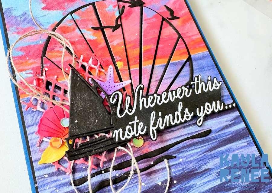Close-up of a handmade card featuring the Stampin’ Up! Scenic Coast Suite, showcasing layered seaside elements including a sailboat die cut, seashells, coral netting, and a bold “Wherever this note finds you…” sentiment over a vibrant sunset ocean background.