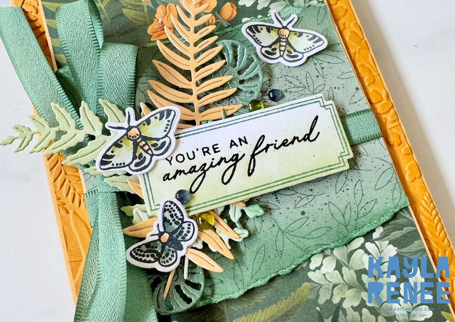 Close-up of a handmade card created for Global Design Project #GDP548 using the Stampin’ Up! Moonlit Flora Suite and new Stampin’ Up! In Colours Golden Glow and Peaceful Pine, featuring layered botanical die cuts, moth images, textured details, and the sentiment “You’re an amazing friend.”