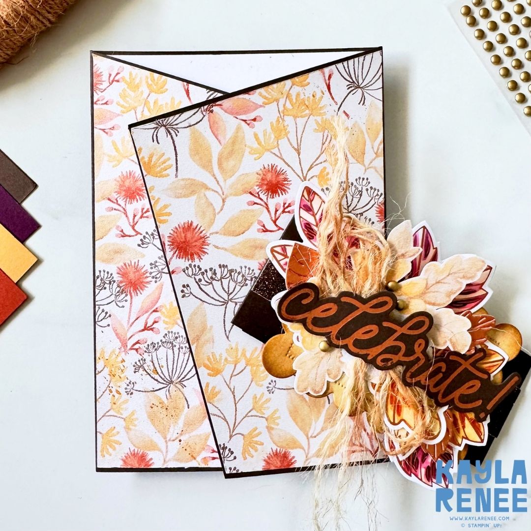 Close-up detail of the angled gatefold card showing layered autumn leaves and flowers, natural fibres, metallic embellishments and a large copper hot-foiled “Celebrate!” sentiment over Glow of Harvest Designer Series Paper.