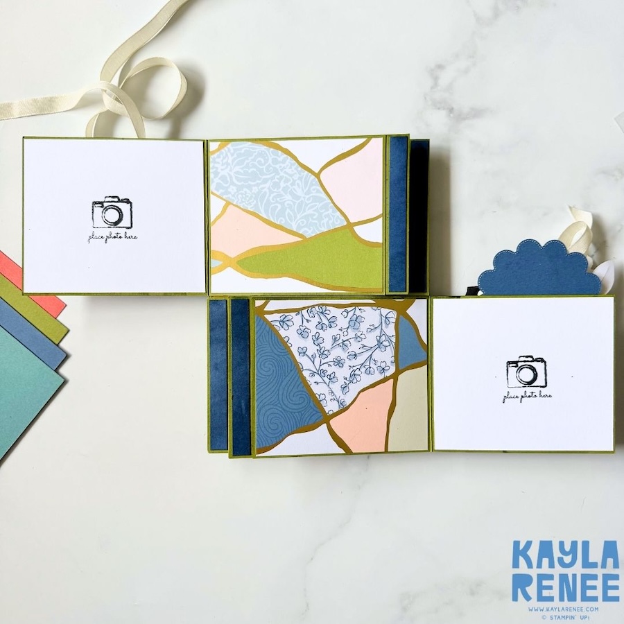 Double flip book card partially opened to reveal two interactive flip panels, decorated with coordinating blue, green, pink and gold patterned paper and spaces for photographs or handwritten messages.
