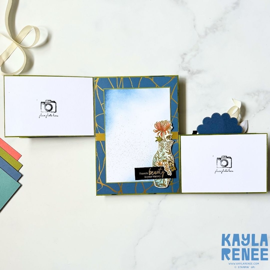 Alt text: Close-up of an interior panel of the double flip book card featuring a blue and gold geometric Kintsugi-inspired background, a decorated floral vase and the sentiment “There’s beauty in your history.”