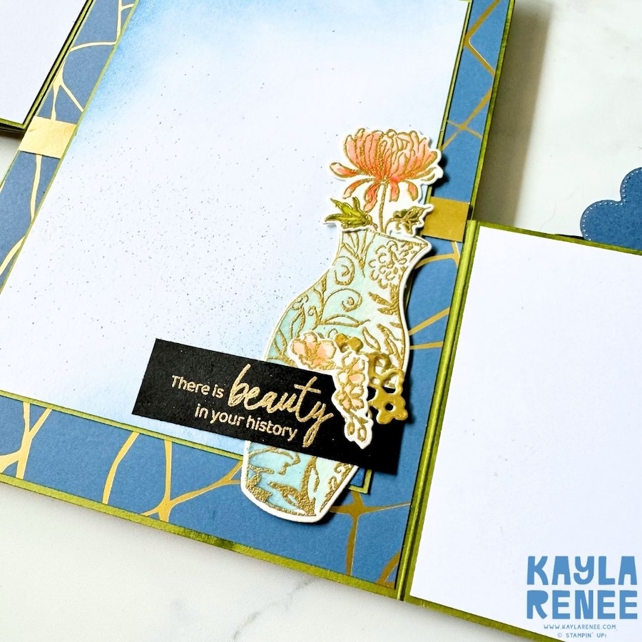 Close-up of another interior panel featuring a delicate gold branch pattern, layered floral vase embellishments and coordinating blue and pink accents.